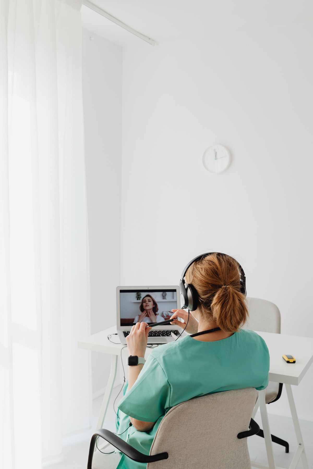 Medica realizando teleconsulta online com paciente, usando tecnologia de IA para documentacao